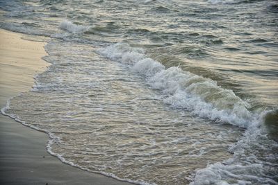 High angle view of waves rushing towards shore