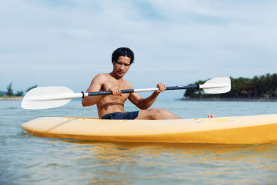 Portrait of man kayaking in sea