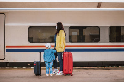 Rear view of people at railroad station