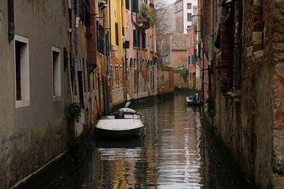 Typical narrow street with historical houses between the canals in venice, italy.