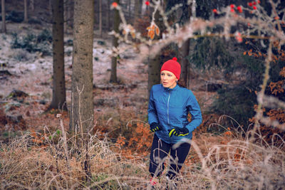 High angle view of woman hiking in forest
