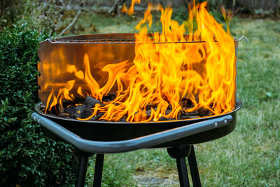 Close-up of yellow fire on grill