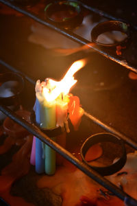 High angle view of lit candles on birthday cake