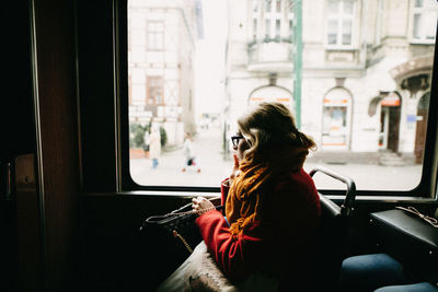 Rear view of woman sitting in car