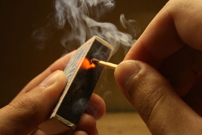 Close-up of hand holding cigarette