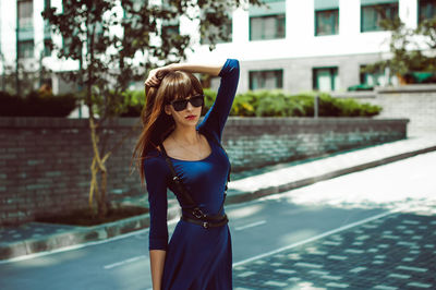 Young woman standing on street in city