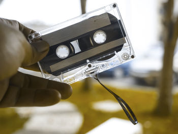 Cropped hand of person holding audio cassette