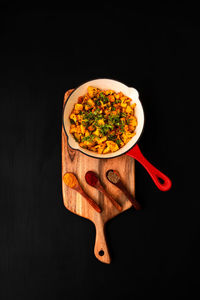 High angle view of salad in bowl against black background