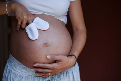 Pregnant woman holding her belly