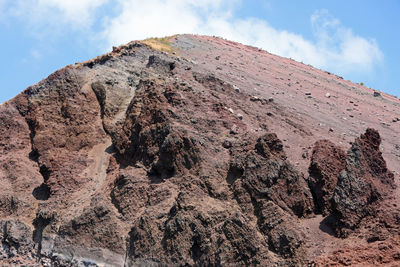 Low angle view of rock formation on land against sky