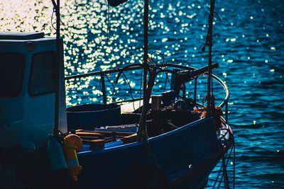 Boat moored on sea seen through window