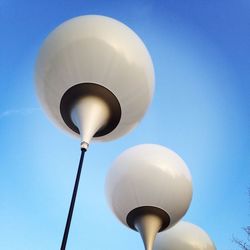 Low angle view of light bulb against blue sky