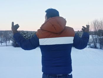 Woman standing on snow covered landscape