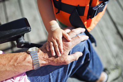 Grandchild and grandfather hands