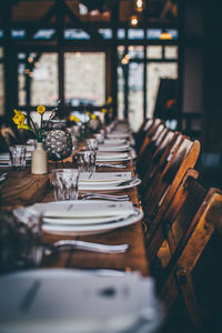 Plates and drinking glasses arranged on restaurant tables