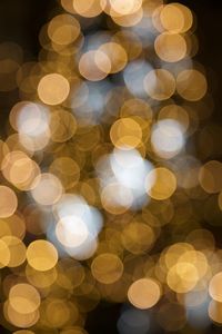 Defocused image of illuminated christmas lights at night