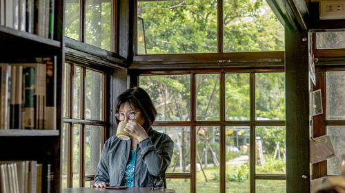 Woman looking through window