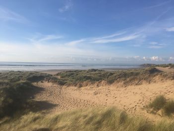 View of beach against cloudy sky