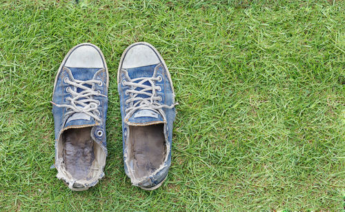 Low section of person wearing shoes on field