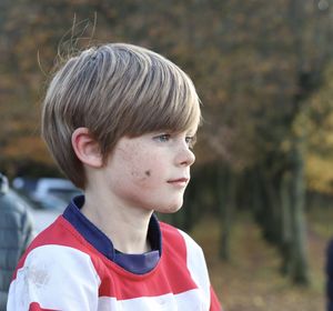 Close-up of boy looking away outdoors