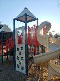 Playground in park against clear sky