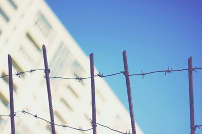 Close-up of barbed wire against clear sky