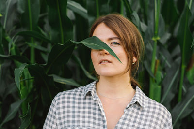 A young girl in a cornfield. unity with nature. caring for the environment