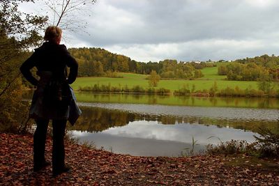 Rear view of man standing in lake