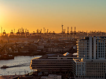 High angle view of buildings in city during sunset