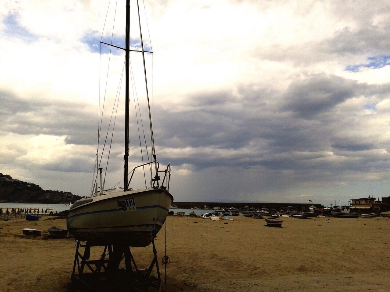 sea, beach, water, sky, nautical vessel, shore, sand, moored, cloud - sky, boat, horizon over water, transportation, tranquility, mode of transport, scenics, tranquil scene, cloudy, nature, mast, sailboat