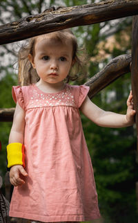 Portrait of cute girl standing in forest