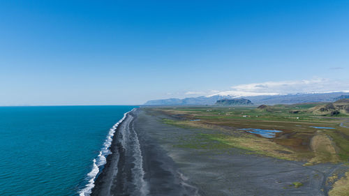 Scenic view of sea against clear blue sky
