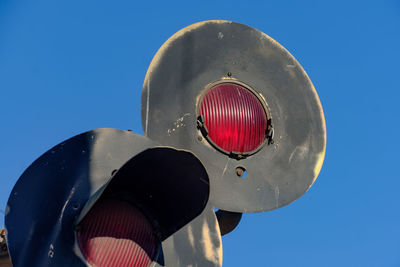 Low angle view of fire hydrant against clear blue sky