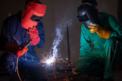 Workers welding metal