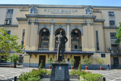 Statue against historic building in city