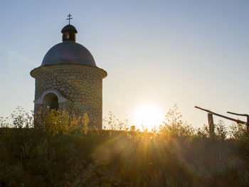 Traditional building against sky during sunset