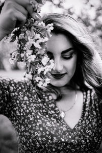 Portrait of beautiful woman with red flower