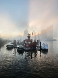 Boats in sea against clear sky