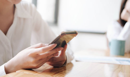 Midsection of woman using mobile phone