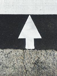 Close-up of arrow symbol on road