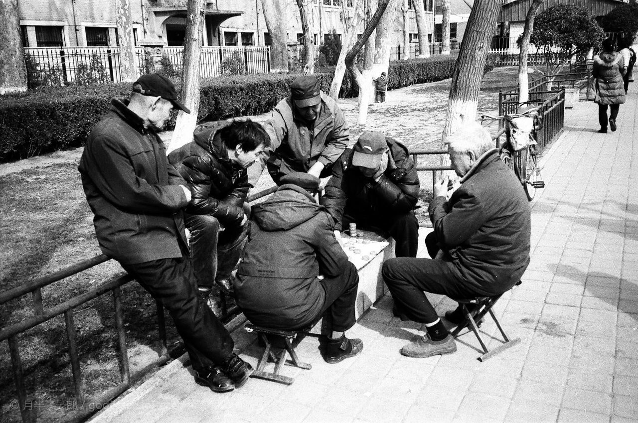 lifestyles, men, leisure activity, casual clothing, togetherness, full length, street, building exterior, person, boys, sitting, built structure, bonding, transportation, land vehicle, walking, high angle view, architecture