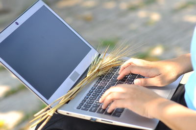 Midsection of person using mobile phone