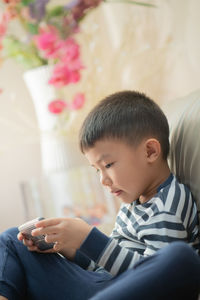 Boy looking away while sitting at home