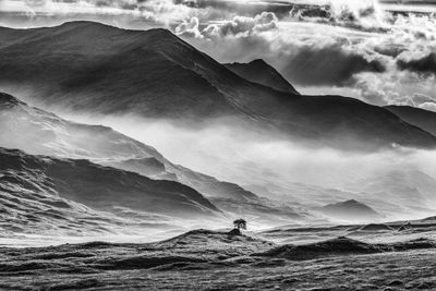 Mountain against cloudy sky during foggy weather