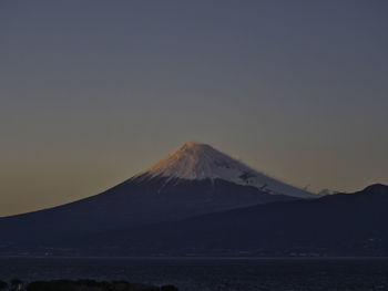 Scenic view of snowcapped mountain against sky during winter