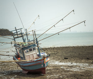 Fishing boat on sea against clear sky