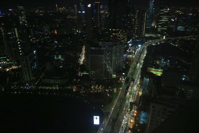 Illuminated cityscape against sky at night
