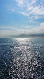 Scenic view of sea against cloudy sky