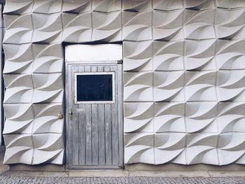 Closed door of house with patterned wall