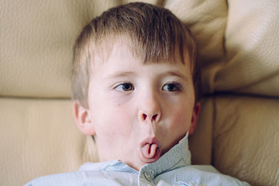 Close-up portrait of cute boy relaxing at home